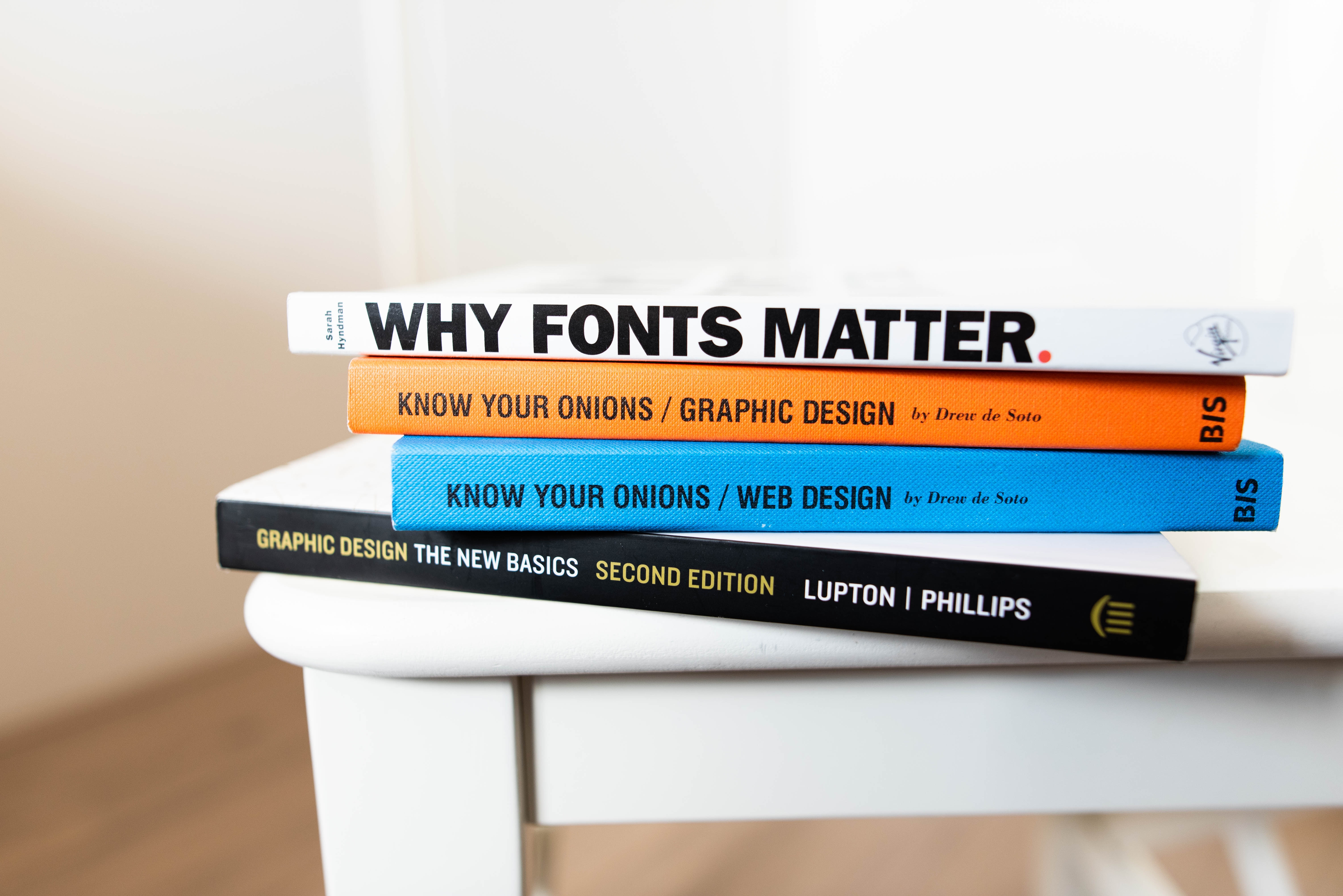 Pile of font books on small table