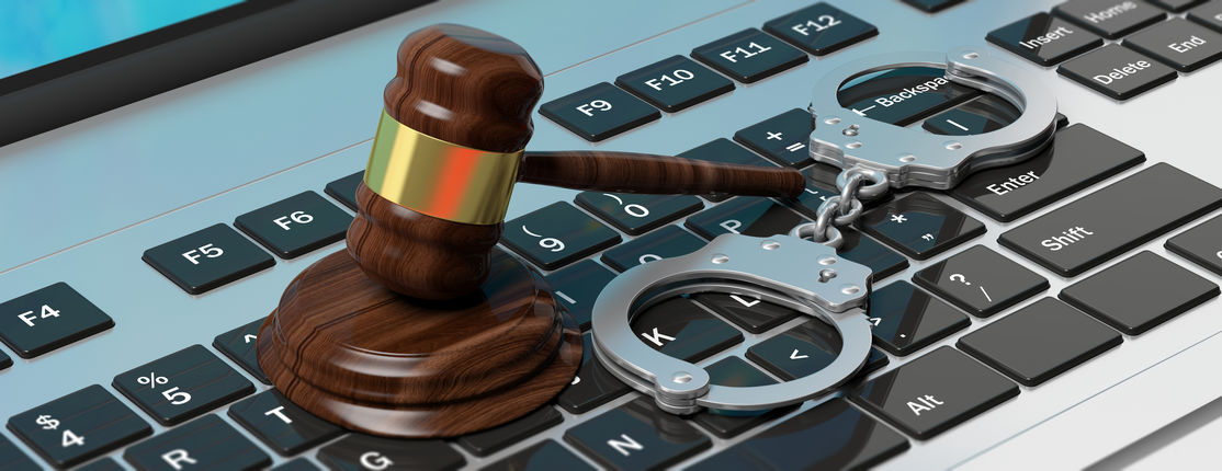 Cyber crime concept. Metal handcuffs and judge gavel on computer keyboard, 3d illustration