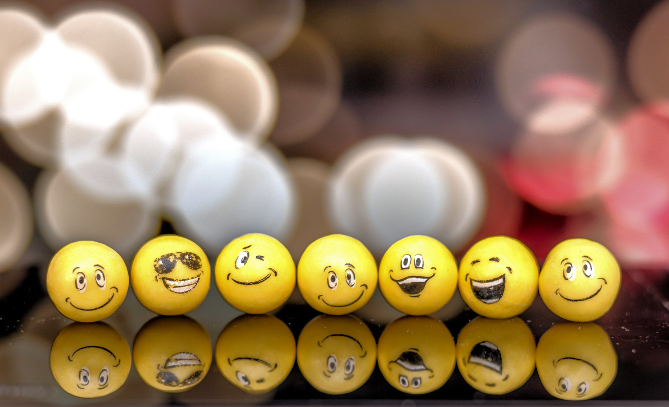 Assorted emoji balls on a table