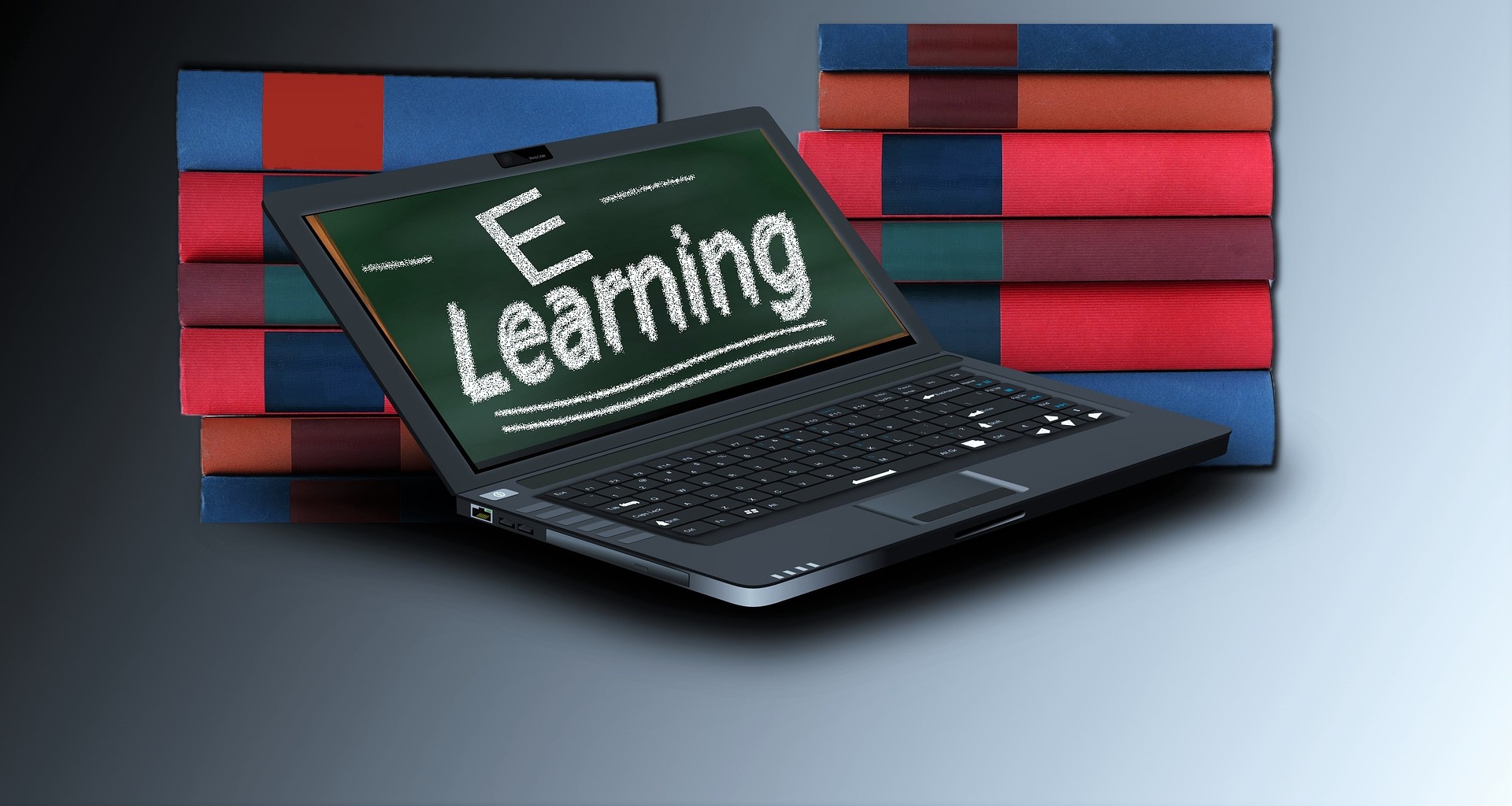 Laptop with the words "e-learning" on screen set against a backdrop of books