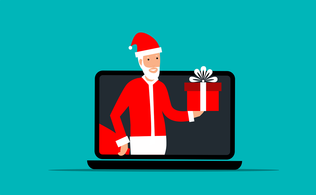 Santa holding a gift from a laptop screen
