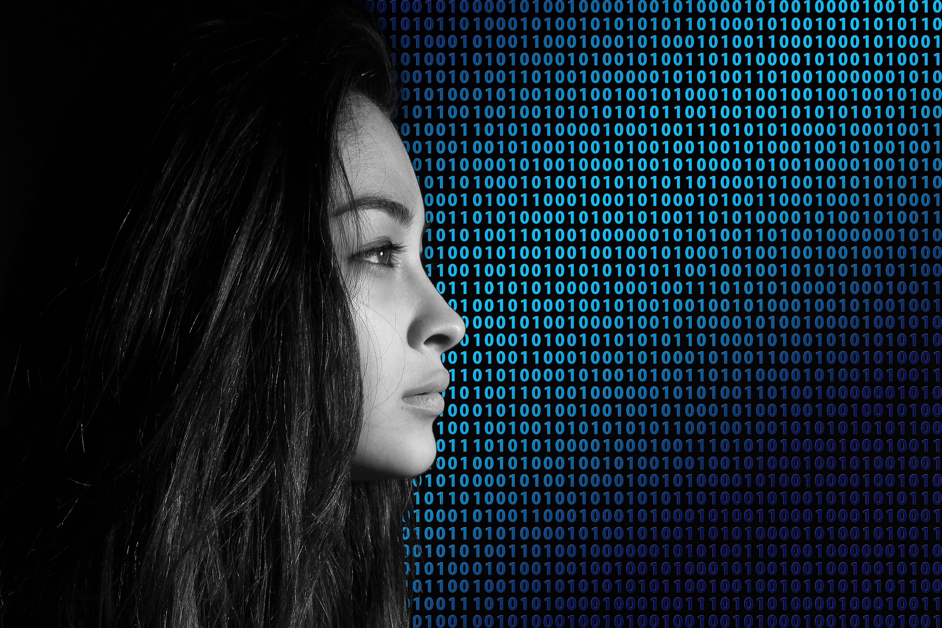 Woman looking at a stream of binary data