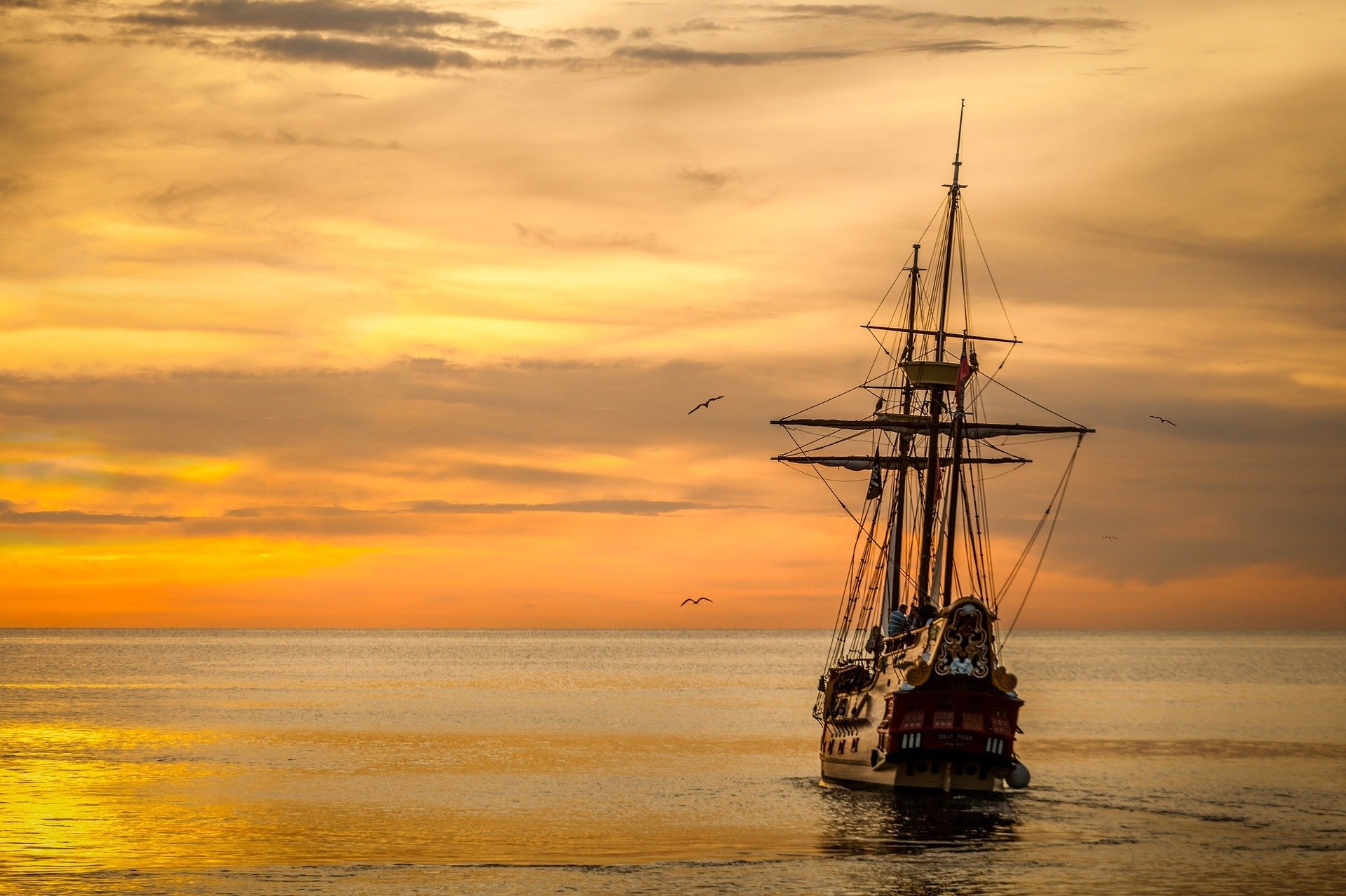 Old ship sailing into the sunset