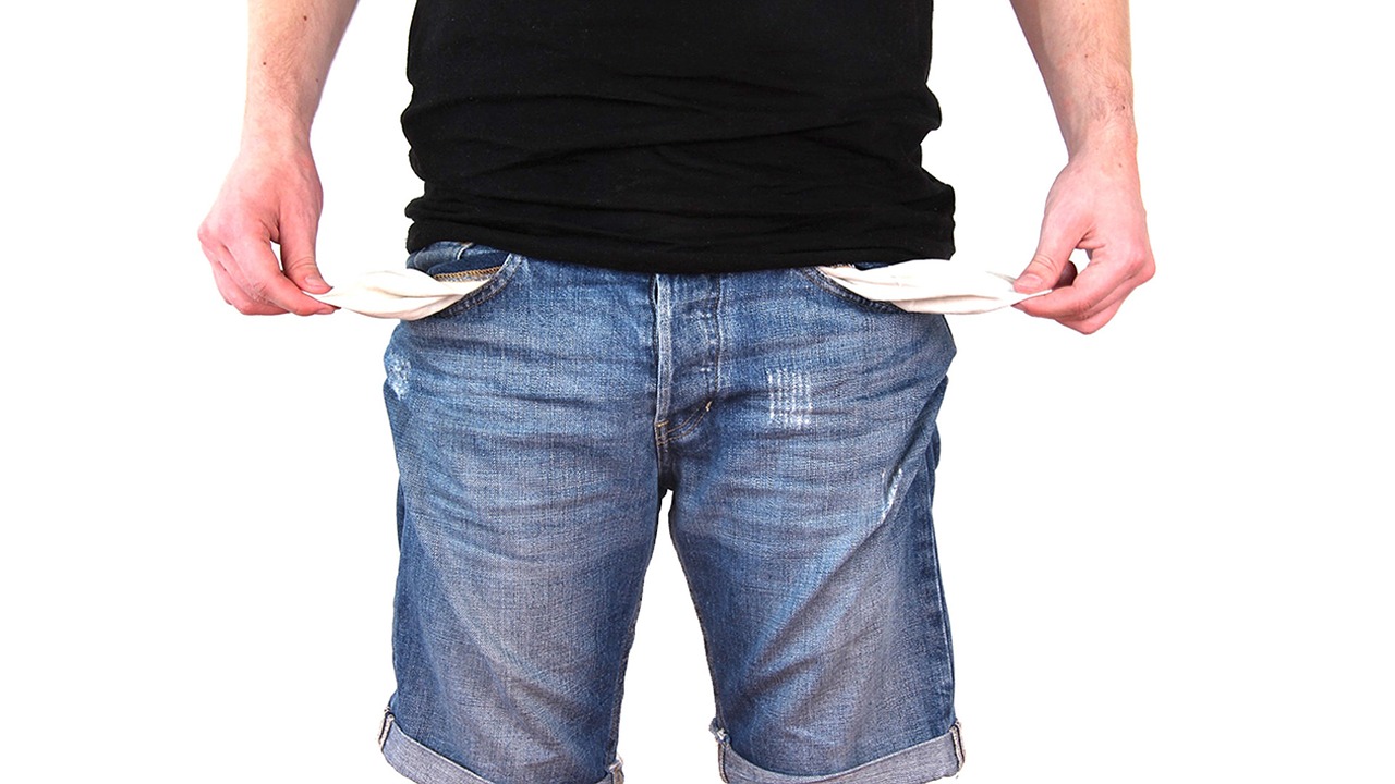 Man showing empty pants pockets