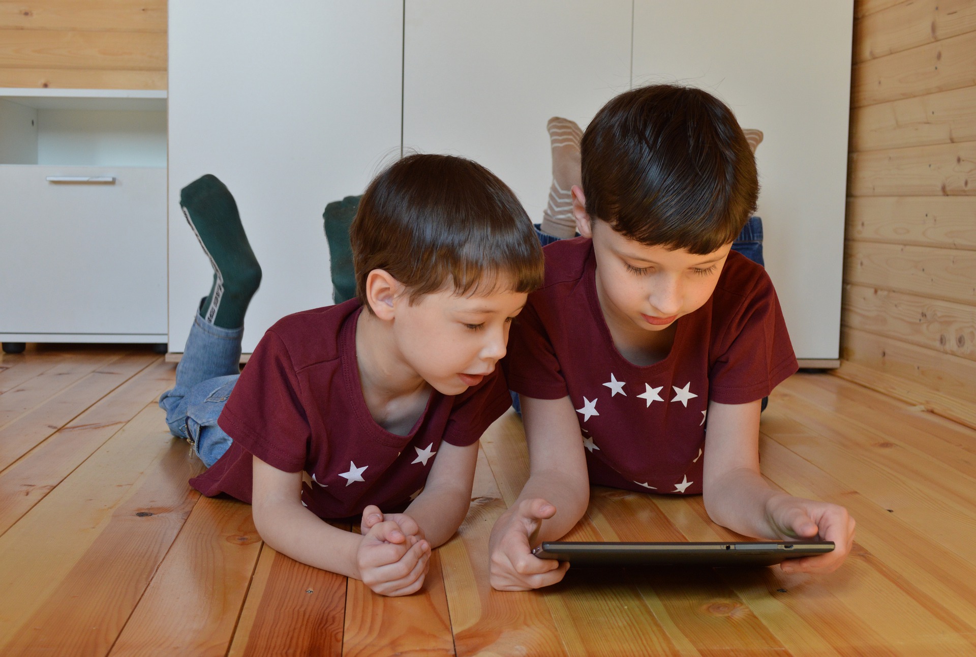 Two boys looking at a tablet